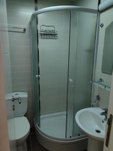 a bathroom with a shower and a toilet and a sink at Apartman Avanti in Budva +32 photos