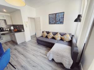 a living room with a couch and a kitchen at Newcastle City Centre, Two Bedroom, Sleeps 6 in Newcastle upon Tyne