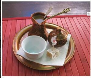 a plate with a vase and a bowl on a table at Apartman Dove in Sarajevo