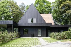 a black house with a black roof at B&B Eat&Sleep in Evergem