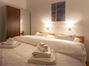 a hotel room with two beds with towels on them at Pannonia Appartements in Neusiedl am See