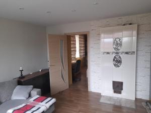 a living room with a couch and a desk at Quiet Summer Apartment in Aucugals