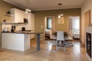 a kitchen and dining room with a table and chairs at Pannonia Appartements in Neusiedl am See