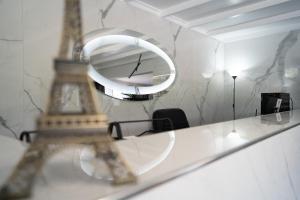 a room with a mirror and the eiffel tower at Parthenis Riviera Hotel in Athens