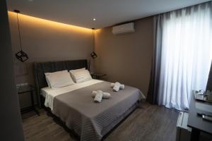 a bedroom with two stuffed animals on a bed at Parthenis Riviera Hotel in Athens