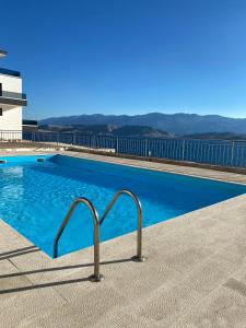 a swimming pool with blue water in a building at Blue Bay Apartments Pag in Pag