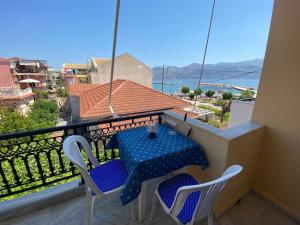 a table and chairs on a balcony with a view at Mariangela Apartments in Lixouri