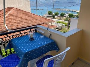 a table and chairs on a balcony with a view at Mariangela Apartments in Lixouri