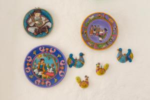a group of plates and figurines on a wall at Hotel Villa Cedrino in Dorgali