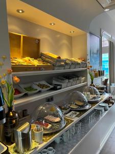 a buffet line with many plates of food at Hotel Clemens in Amsterdam
