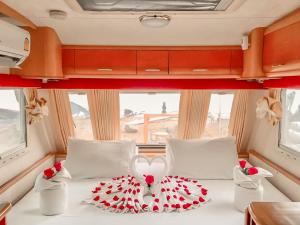 a bed in the middle of a camper with a red and whiteussion at Beach House Camp in Na Jomtien