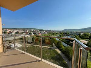 a balcony with a view of a city at Fortuna Panorama Apartman in Odorheiu Secuiesc