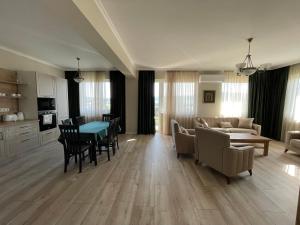 a living room with a couch and a table at Fortuna Panorama Apartman in Odorheiu Secuiesc