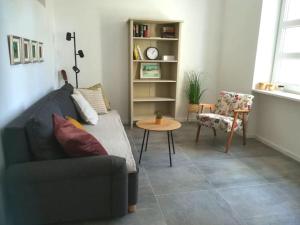 a living room with a couch and a table and a chair at Lovely apartment in the city center in Pula