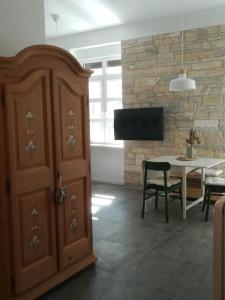 a kitchen with a cabinet and a table and a dining room at Lovely apartment in the city center in Pula