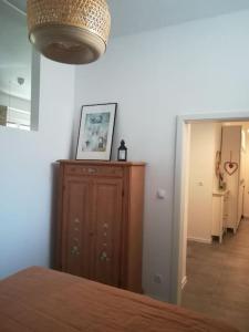 a bedroom with a bed and a dresser and a hallway at Lovely apartment in the city center in Pula