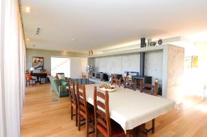 a dining room and living room with a table and chairs at Quinta Pedras De Baixo in Longos