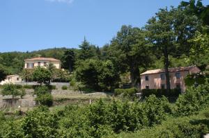 a house on a hill with trees and bushes at Valle Maira, Agriturismo nel Parco dei Nebrodi in Tortorici