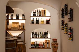 a room with shelves of wine bottles on the wall at Hotel Villa Cedrino in Dorgali
