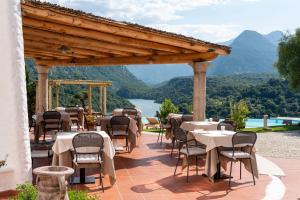 a restaurant with tables and chairs on a patio with a view at Hotel Villa Cedrino in Dorgali