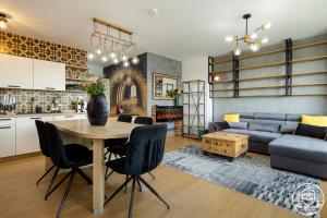 a living room with a table and a blue couch at Apartments M&M Kołobrzeg Polanki in Kołobrzeg