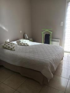- une chambre avec un grand lit et des draps blancs dans l'établissement Mon appartement de vacances, à Valras-Plage