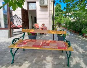 a bench sitting outside of a house with a sidx sidx at Room soba u Opatiji Na Lipovici in Opatija