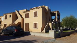 a house with a car parked in front of it at Casetta Francy in San Teodoro