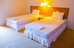Postel nebo postele na pokoji v ubytování Sweet Home Hotel Betong