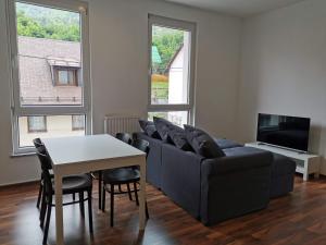 a living room with a couch and a table at Apartma Valan in Bovec