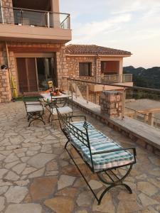 a patio with chairs and a table on a house at Lavender House 1 - Agios Nikitas in Agios Nikitas
