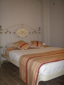a bed with two pillows on it in a bedroom at Lavender House 1 - Agios Nikitas in Agios Nikitas