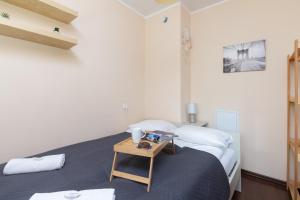 a bedroom with a bed with a table on it at Gdansk Zabianka Sztormowa Apartment with 1 Bedroom by Renters in Gdańsk
