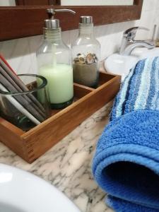 a bathroom counter with a soap dispenser and a candle at Peniche Blue Wave Home in Peniche