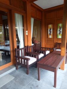 a row of wooden benches in a room at Villa Dua Bintang in Munduk