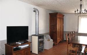 a living room with a television and a stove at 2 Bedroom Nice Home In Trambly in Trambly