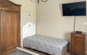 a bedroom with a bed and a flat screen tv at 2 Bedroom Nice Home In Trambly in Trambly +7 photos