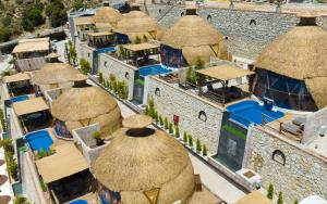 an overhead view of a group of buildings with thatched roofs at La Lucci Fethiye in Karaagac
