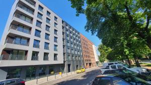 a yellow car parked in front of a building at AJP Nova3 Lux Apartament in Szczecin