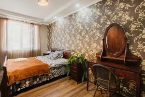 a bedroom with a bed and a mirror at Marcos Hotel in Nizhnyaya Alekseyevka