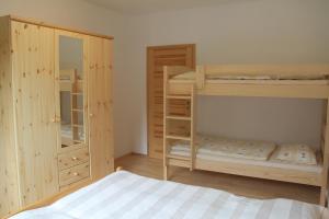 a bedroom with two bunk beds and a mirror at Cozy apartment in Bedřichov - Špindlerův Mlýn in Špindlerův Mlýn