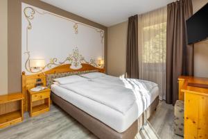 Postel nebo postele na pokoji v ubytování Hotel Vittoria - Ricarica l'anima