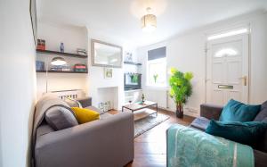 a living room with a couch and a table at Bright 3 bedroom townhouse near city centre in Norwich
