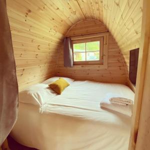a bedroom with a bed and a window at Camping La Ferme de Castellane in Castellane
