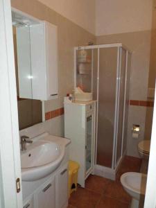 a bathroom with a sink and a shower in it at Le Anfore di Arpi in Foggia