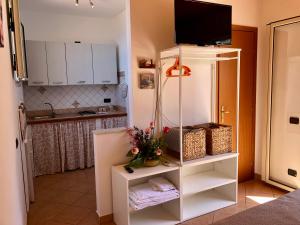 a kitchen with a tv on top of a refrigerator at La Casa Sulla Scogliera in Cefalù