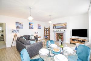 a living room with a couch and a table at Captain's Retreat in Weymouth