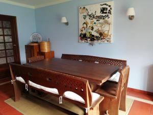 a dining room with a wooden table and chairs at Peniche Blue Wave Home in Peniche