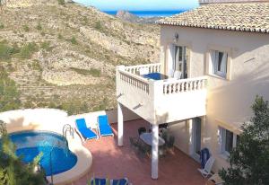 a house with a balcony and a swimming pool at Nice villa beautiful view in Pedreguer