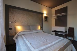 a bedroom with a large bed and a flat screen tv at Villa Mirella in Bordighera